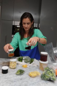 Sweet Roots NYC customer Carolyn Lanzetta unpacks two ready-to-cook.